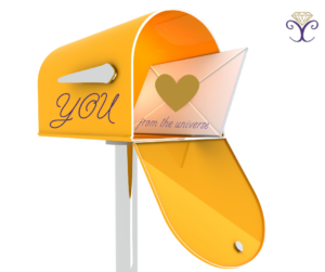 An orange mailbox sits with the door open and the word 'You' written on the outside. There is an envelope inside that says 'from the universe' and sealed with a gold heart. 