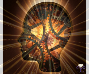 An image of gears within a person's head and a burst of gold light coming from the center of their head.